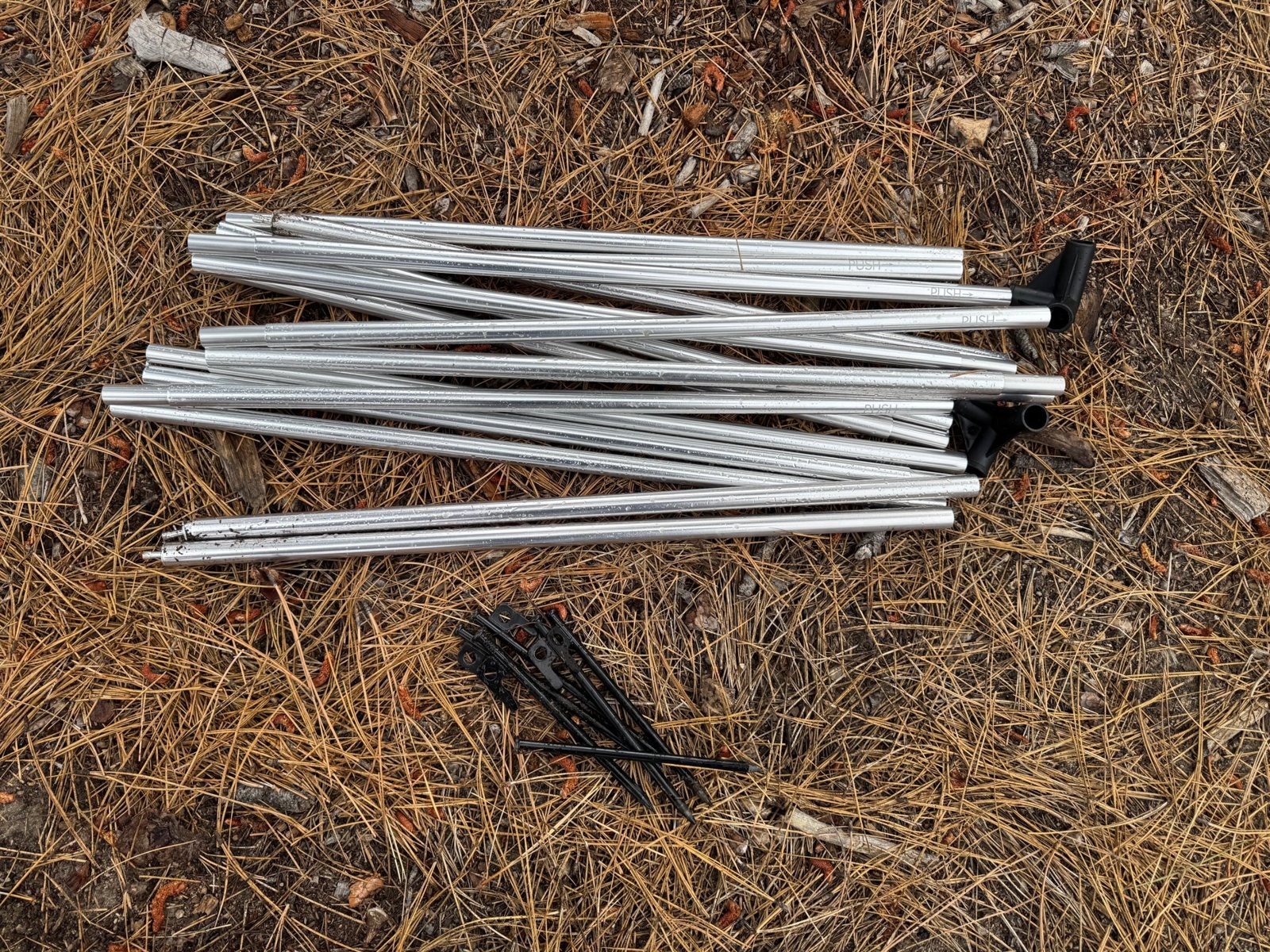 Sky View XL Poles, Connectors and Stakes Sky View XL poles, corner connectors and black steel stakes on pine needles