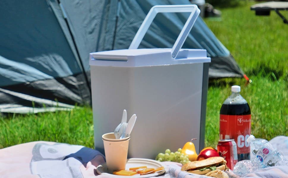 Koolatron 18 qt electric cooler at camp Koolatron 18 qt electric cooler on a picnic blanket in front of a tent