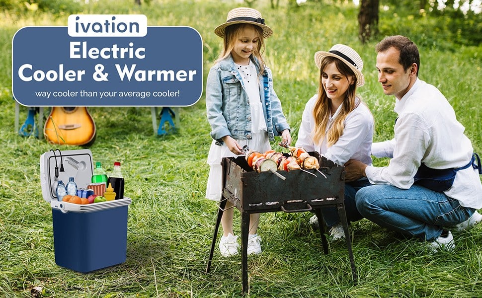 Ivation 25 L electric cooler and warmer at a picnic Ivation 25 L electric cooler and warmer beside a family grilling at a picnic