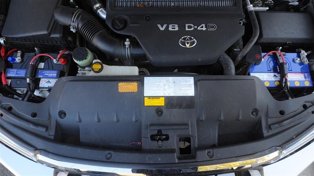 Dual battery setup in a LandCruiser 200 Series engine bay LandCruiser 200 Series engine bay with the starter battery on one side and a second battery on the other