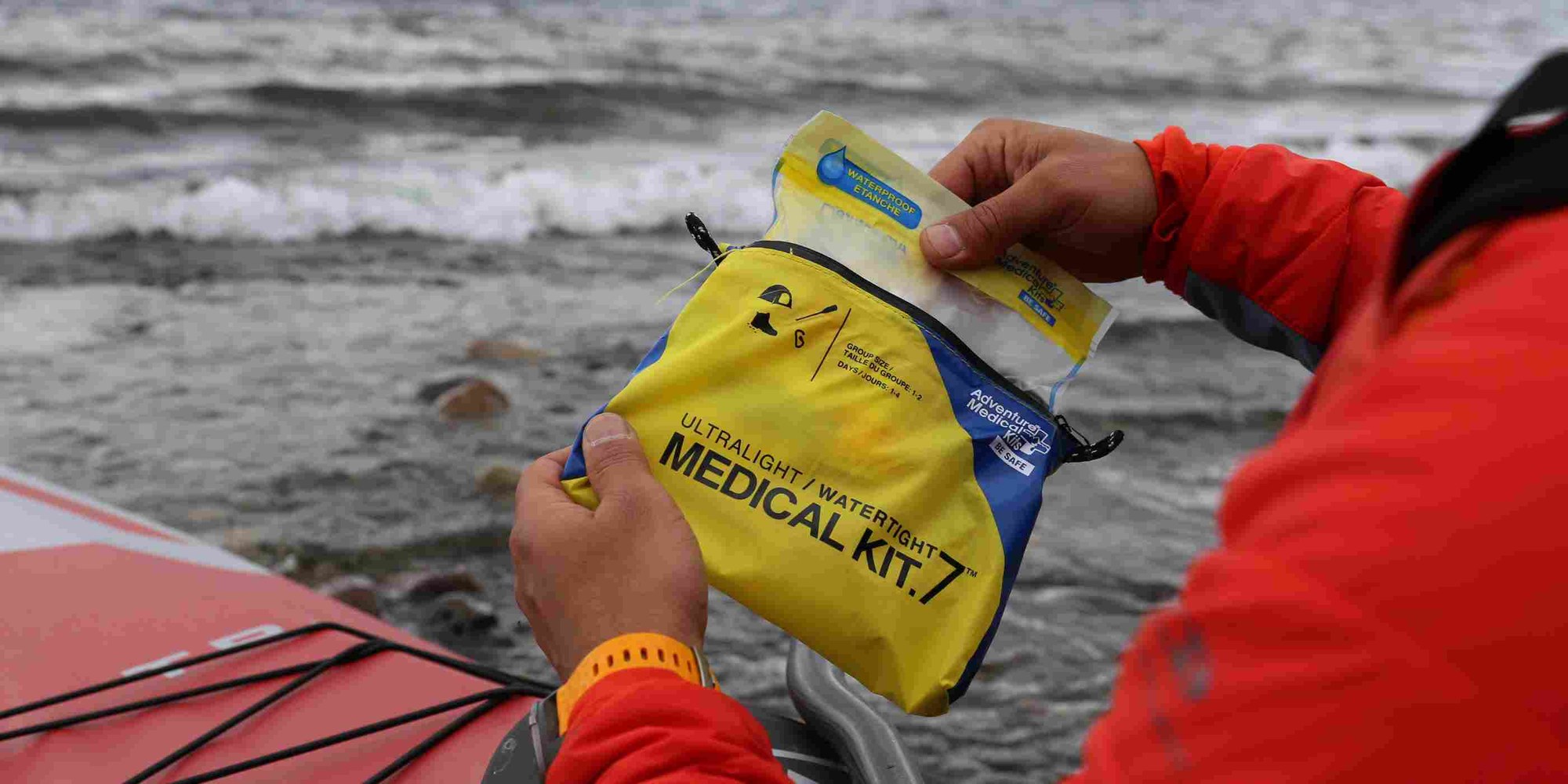 Adventure Medical Kits Ultralight/Watertight .7 first aid kit Hiker holding the Adventure Medical Kits Ultralight/Watertight .7 first aid kit beside a river