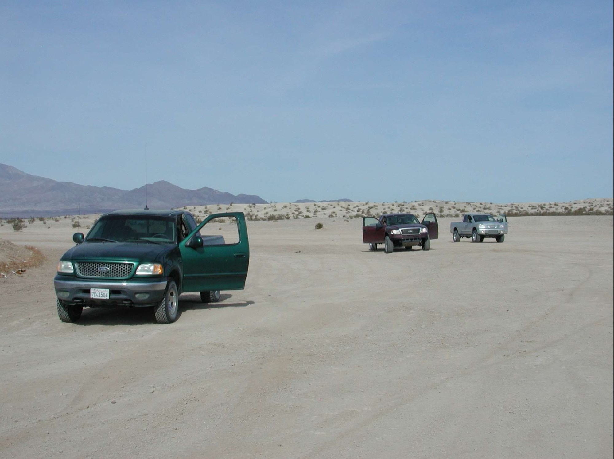 Ford F-150 development trucks parked on a desert lakebed during early Raptor testing
