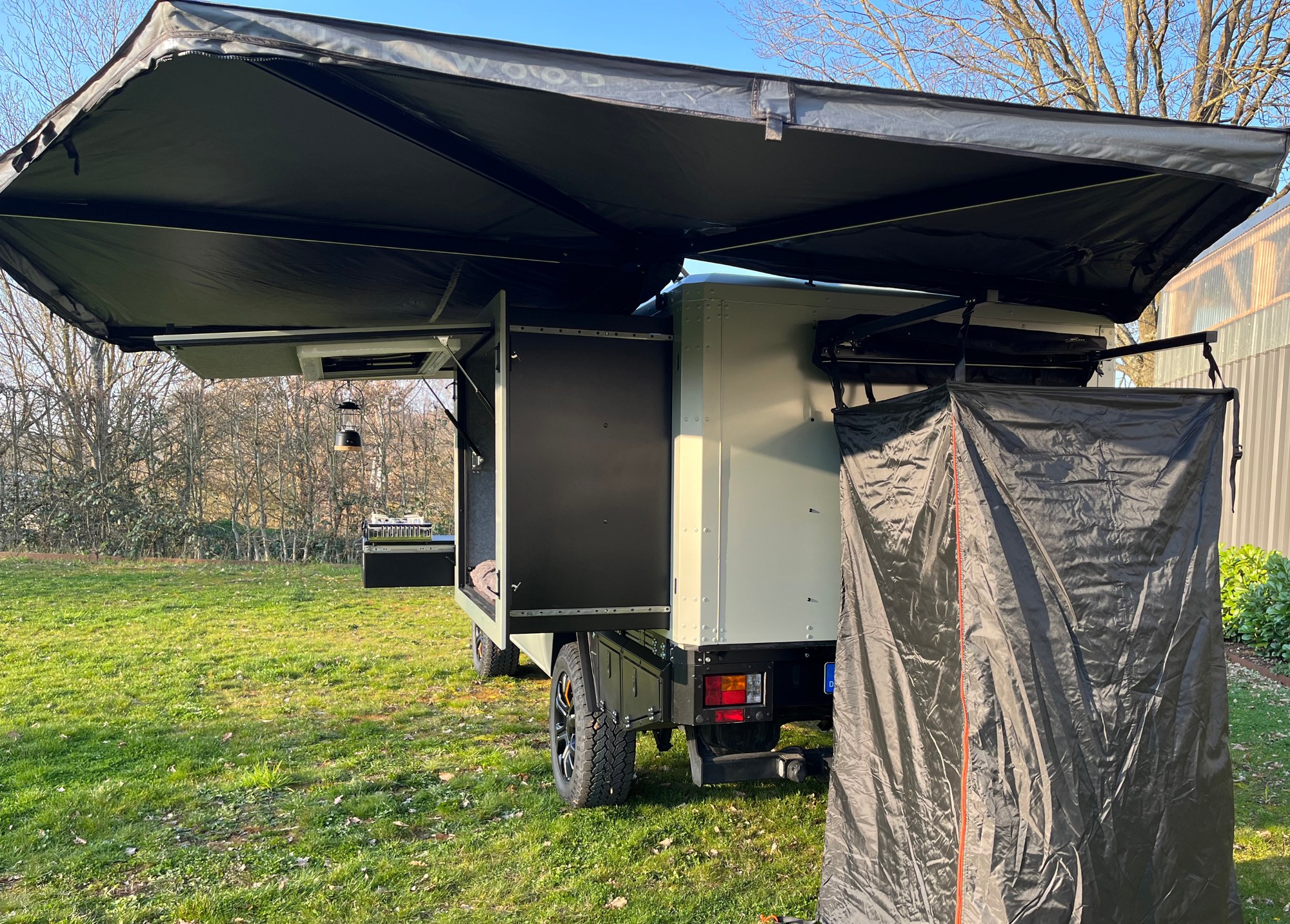 Unbounder X awning and shower enclosure Unbounder X awning and shower enclosure deployed at the rear of the pickup