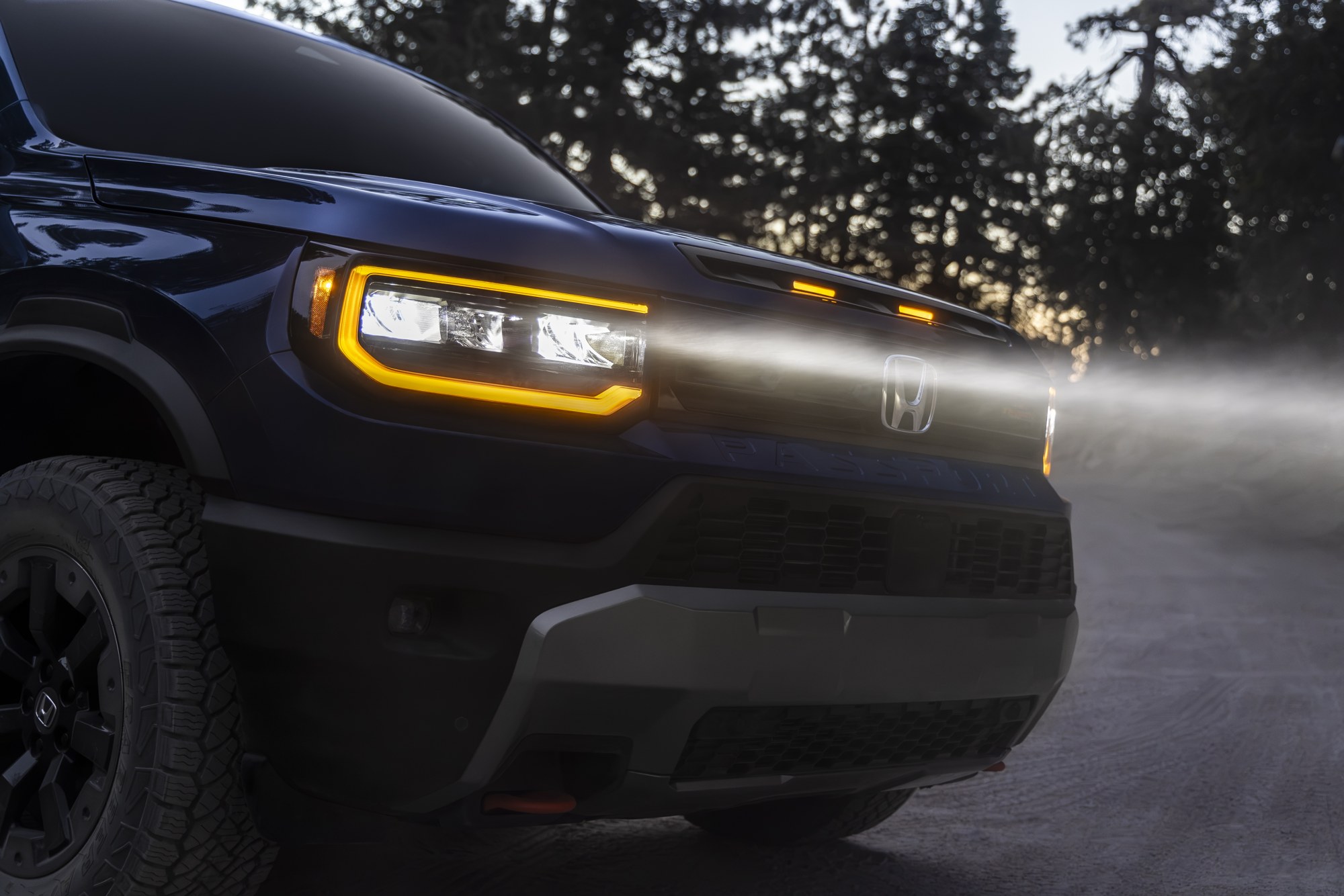 2027 Honda Passport TrailSport 2027 Honda Passport TrailSport on a forest dirt road at dusk, the closest Honda SUV to the Acura TDX