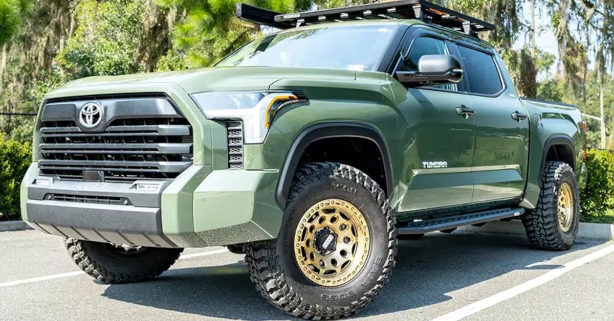 Go Rhino RB20 Slim running boards Go Rhino RB20 Slim running boards mounted on a green pickup truck with a roof rack