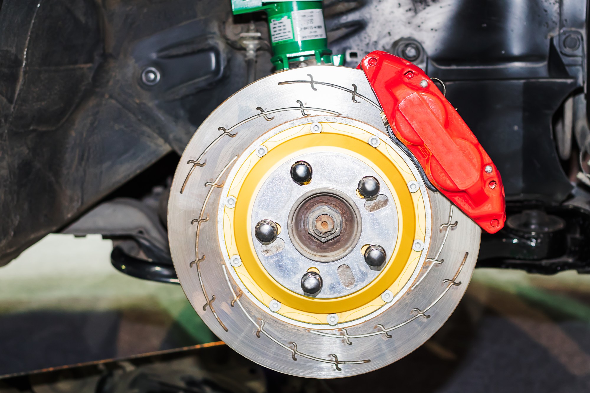 Wheel hub, lug studs and center bore Wheel hub with lug studs and center bore exposed beside the rotor and caliper during a wheel swap