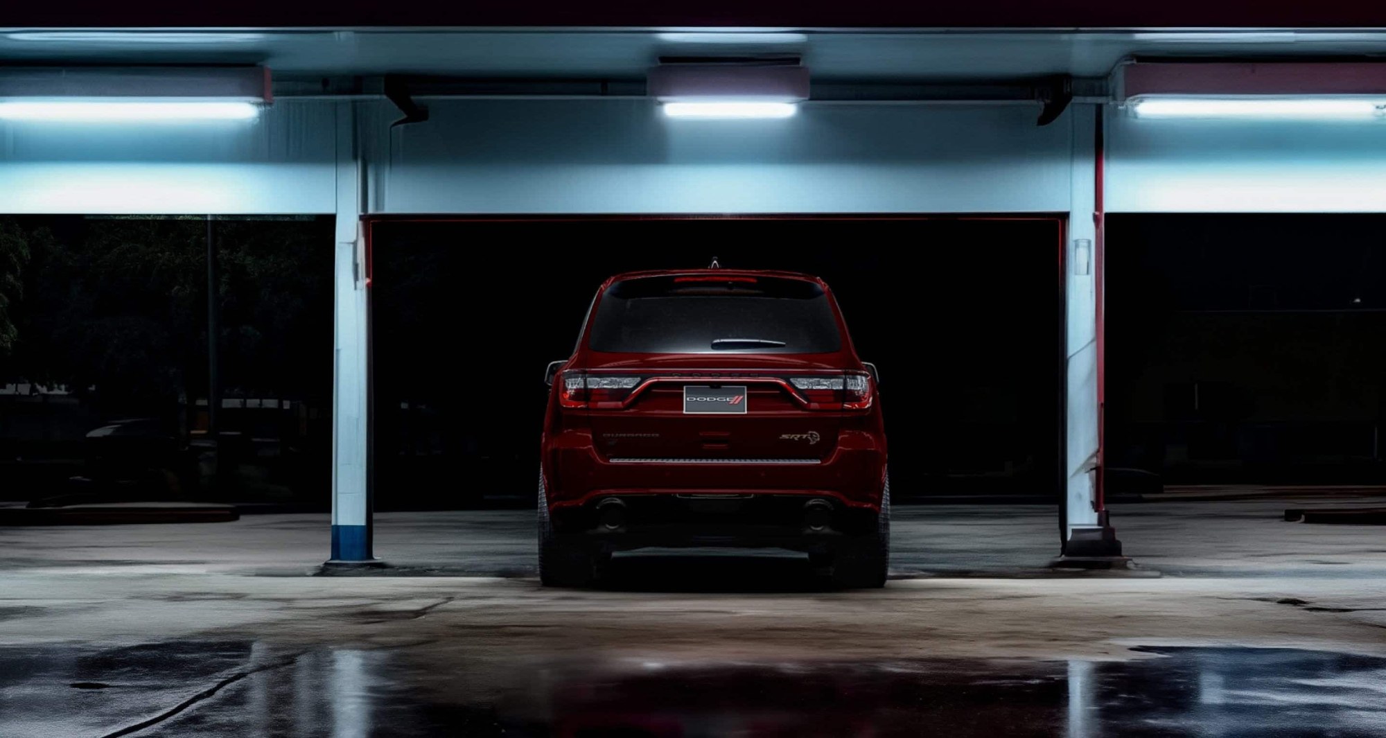 Rear angle of a red 2026 Dodge Durango SRT Hellcat in a lighted parking structure