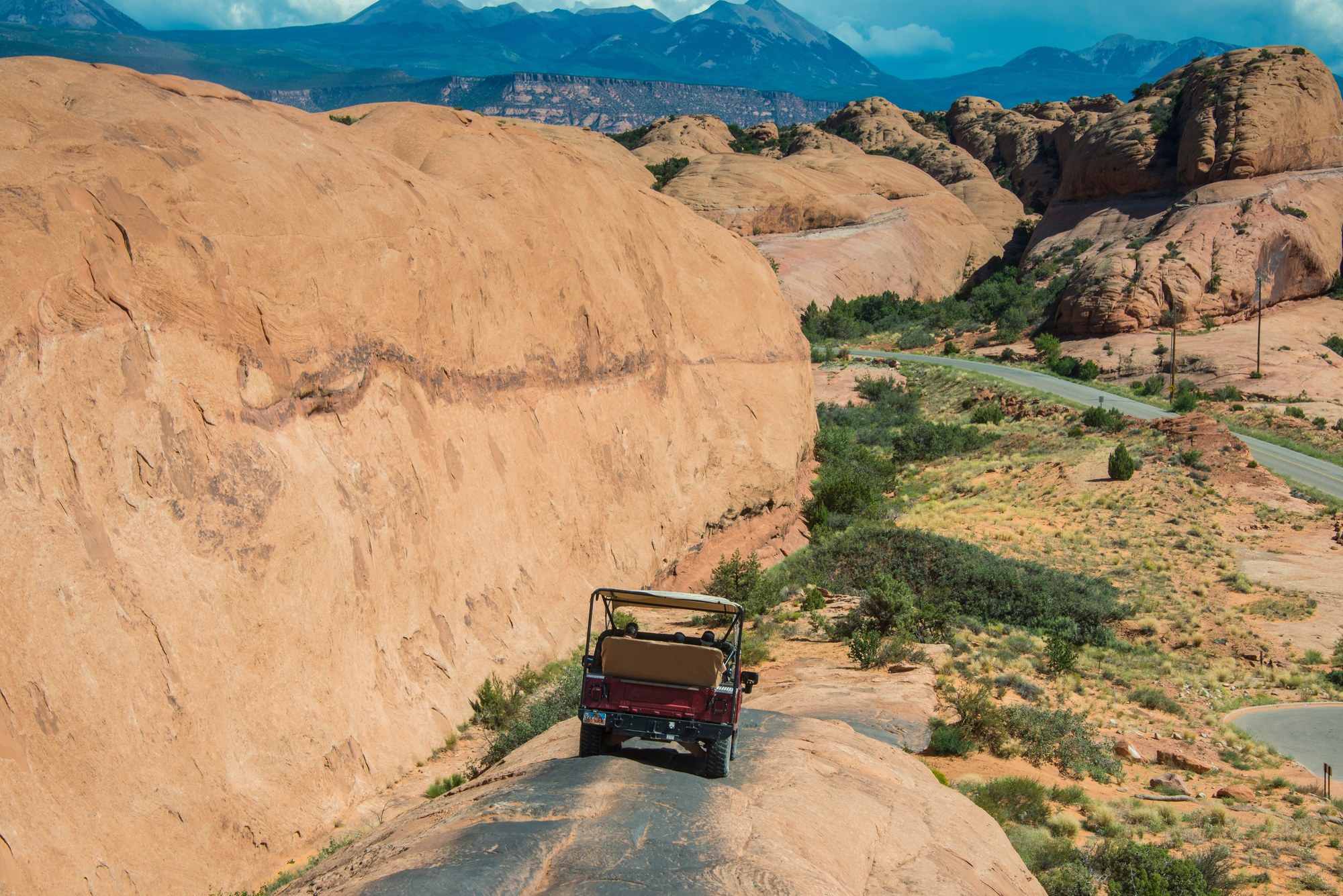 Open-top Hummer tour vehicle driving the Slickrock trail above Moab, Utah